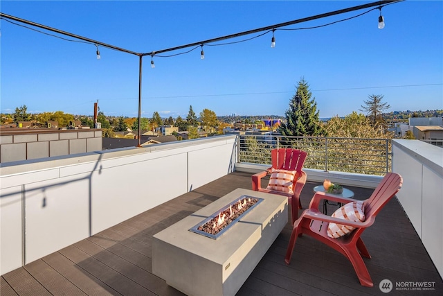 wooden deck featuring a fire pit