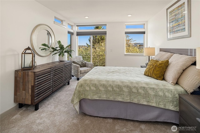 carpeted bedroom with baseboards and access to outside