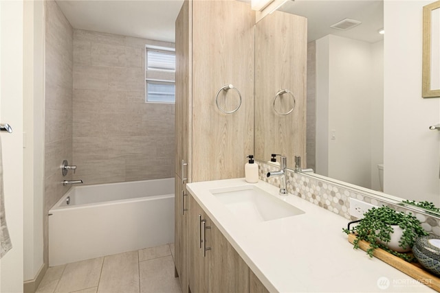 full bath featuring tile patterned floors,  shower combination, toilet, visible vents, and vanity