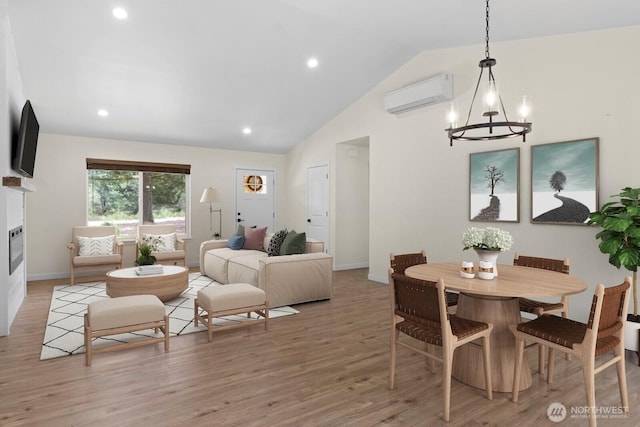 902W California Rd, Shelton, WA 98584 - dining room featuring a wall mounted AC, a chandelier, lofted ceiling, baseboards, and light wood-style flooring