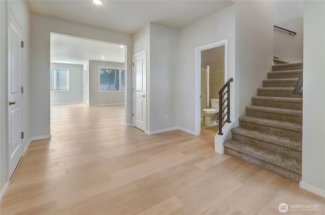 interior space with recessed lighting, baseboards, stairs, and light wood-type flooring