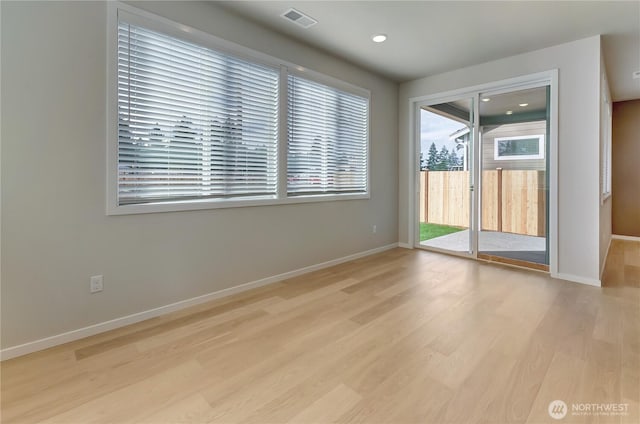empty room featuring recessed lighting, light wood-type flooring, visible vents, and baseboards