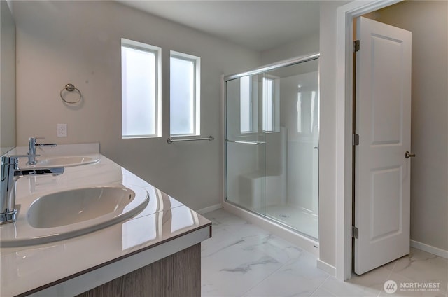 bathroom with marble finish floor, baseboards, and a sink