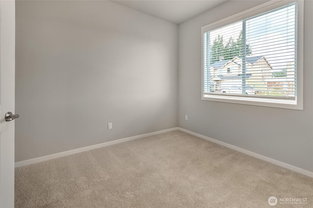 empty room with light carpet and baseboards