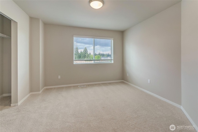 empty room with baseboards and carpet floors