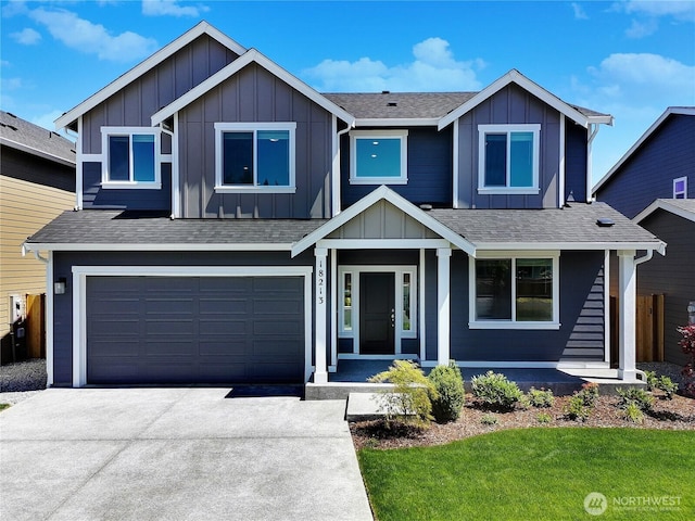 18213 35th Avenue Ct E, Tacoma, WA 98446 - view of front of home featuring board and batten siding, concrete driveway, a shingled roof, and an attached garage