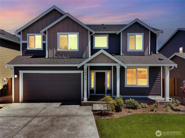 18213 35th Avenue Ct E, Tacoma, WA 98446 - view of front of home featuring board and batten siding, an attached garage, driveway, and a shingled roof