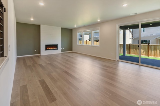 18213 35th Avenue Ct E, Tacoma, WA 98446 - unfurnished living room featuring wood finished floors, a fireplace, and recessed lighting