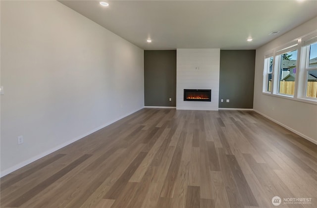 18213 35th Avenue Ct E, Tacoma, WA 98446 - unfurnished living room featuring a large fireplace, wood finished floors, and recessed lighting