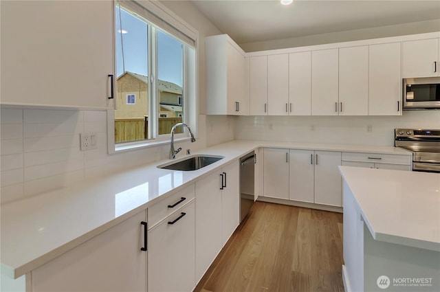 18213 35th Avenue Ct E, Tacoma, WA 98446 - kitchen featuring appliances with stainless steel finishes, decorative backsplash, and light countertops