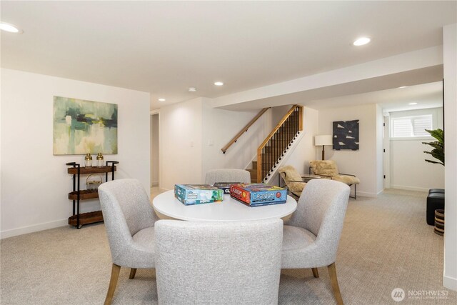 dining room featuring light carpet, baseboards, recessed lighting, and stairway