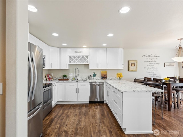 17581 110th Ln SE Unit 3, Renton, WA 98055 - kitchen featuring appliances with stainless steel finishes, a peninsula, white cabinetry, and recessed lighting