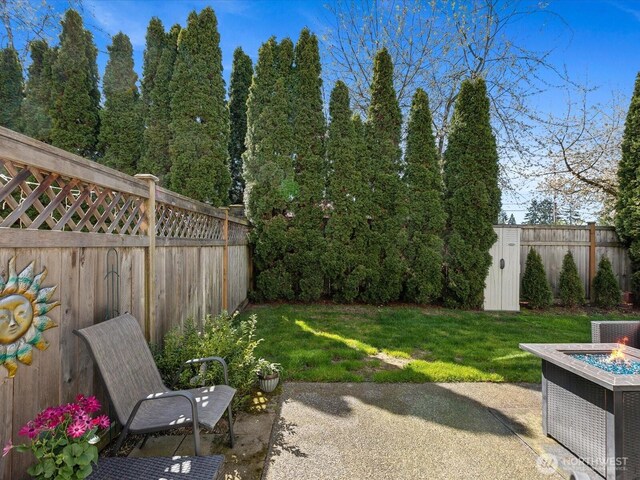 17581 110th Ln SE Unit 3, Renton, WA 98055 - view of yard featuring an outdoor fire pit, a patio, a shed, and an outdoor structure
