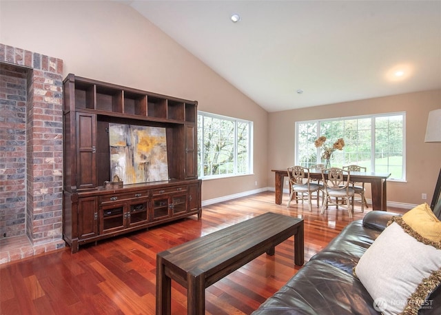 living room with recessed lighting, wood finished floors, a wealth of natural light, and baseboards