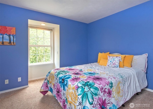 carpeted bedroom featuring baseboards