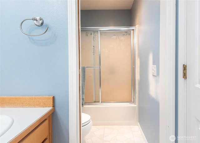 bathroom with tile patterned flooring, toilet, vanity, and bath / shower combo with glass door