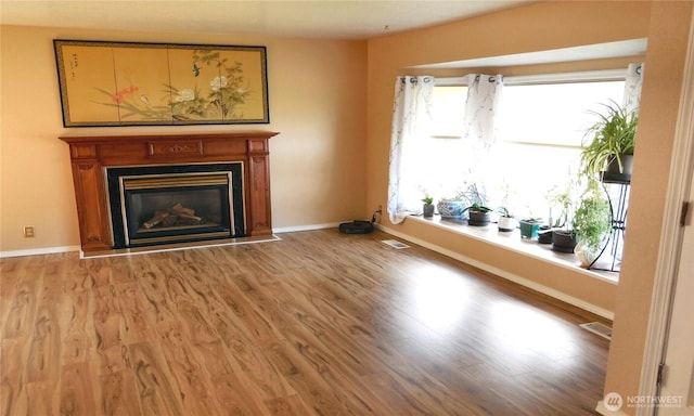 5036 Beach Way NE, Olympia, WA 98516 - unfurnished living room with wood finished floors and a glass covered fireplace