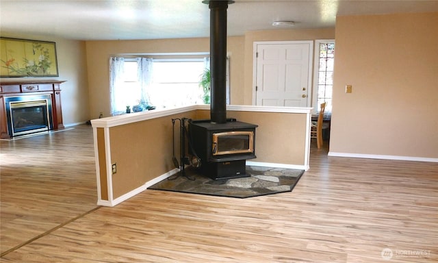 5036 Beach Way NE, Olympia, WA 98516 - living room with a wood stove, wood finished floors, and a fireplace