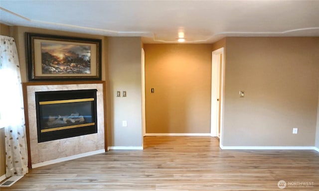 5036 Beach Way NE, Olympia, WA 98516 - unfurnished living room with light wood-type flooring and a tiled fireplace