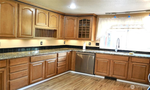 5036 Beach Way NE, Olympia, WA 98516 - kitchen featuring dishwasher, brown cabinetry, dark stone counters, light wood-style floors, and a textured ceiling