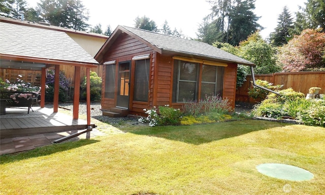 5036 Beach Way NE, Olympia, WA 98516 - back of property with an outdoor structure, a shingled roof, and a deck