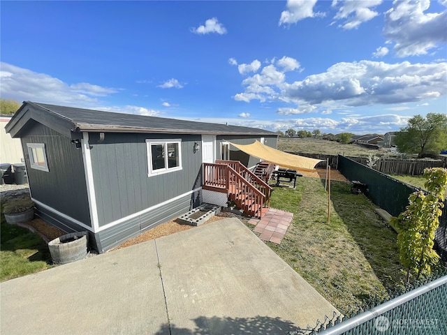 view of front of property with fence and a patio area