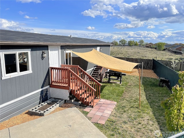 property entrance with a yard, a patio, and fence