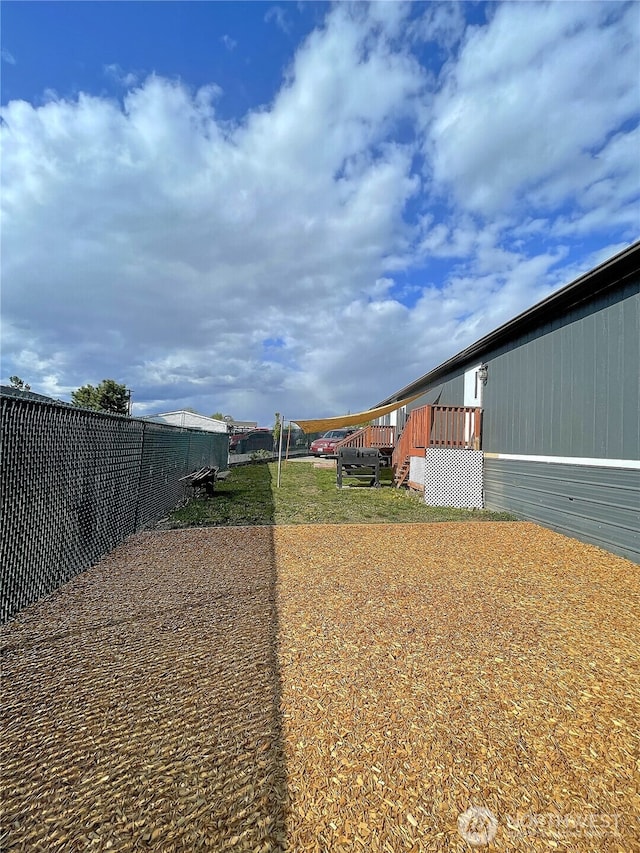 view of yard with fence and a deck
