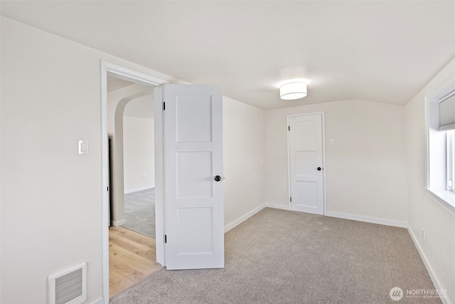 additional living space with baseboards, carpet, and visible vents