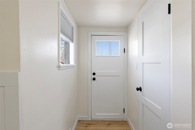 entryway with light wood-style floors and baseboards