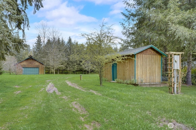 1319 Winlock Vader Rd Unit 19, Winlock, WA 98596 - view of grassy yard featuring an outdoor structure and a detached garage