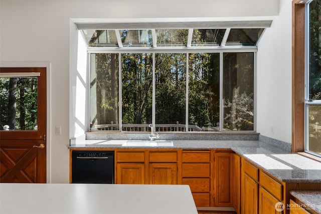 interior space with dishwasher and a sink