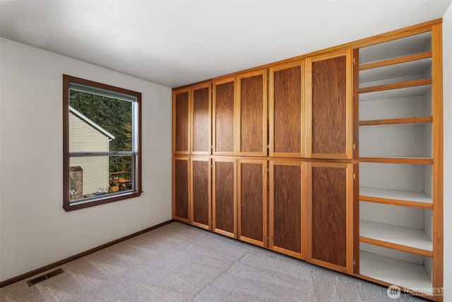 interior space featuring carpet, visible vents, and baseboards