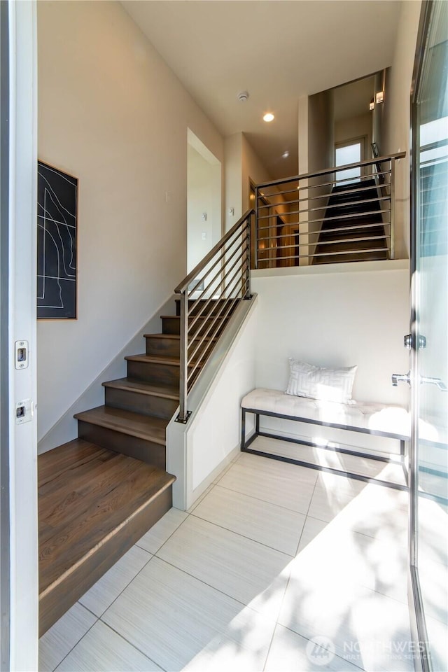 stairway featuring recessed lighting and tile patterned flooring