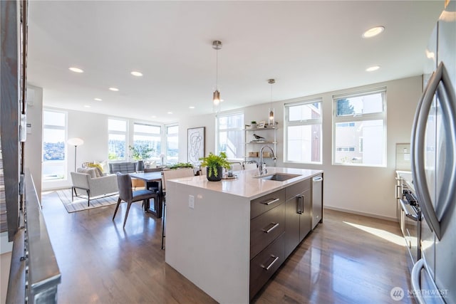 kitchen with dark wood-type flooring, stainless steel appliances, modern cabinets, and a sink