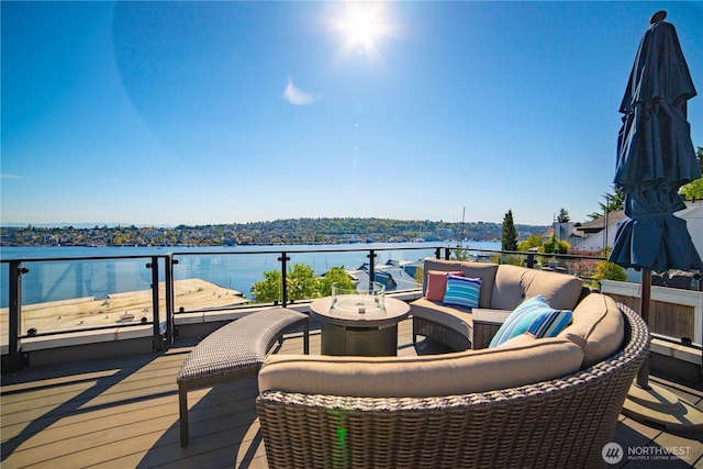 deck featuring an outdoor living space and a water view