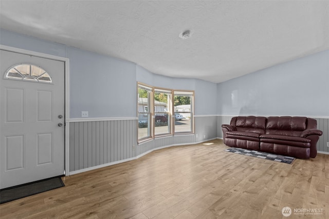 11519 21st Ave E Unit 84, Tacoma, WA 98445 - entryway featuring a textured ceiling, wood finished floors, and wainscoting