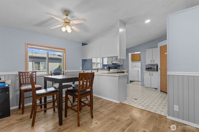 11519 21st Ave E Unit 84, Tacoma, WA 98445 - dining space with a wainscoted wall, light wood-style flooring, a ceiling fan, and washer / dryer