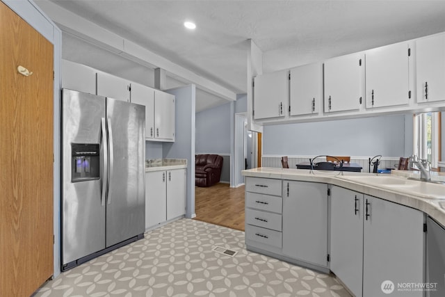 11519 21st Ave E Unit 84, Tacoma, WA 98445 - kitchen with light floors, light countertops, a sink, and stainless steel refrigerator with ice dispenser