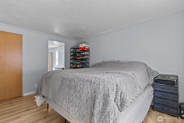 11519 21st Ave E Unit 84, Tacoma, WA 98445 - bedroom with a textured ceiling and wood finished floors