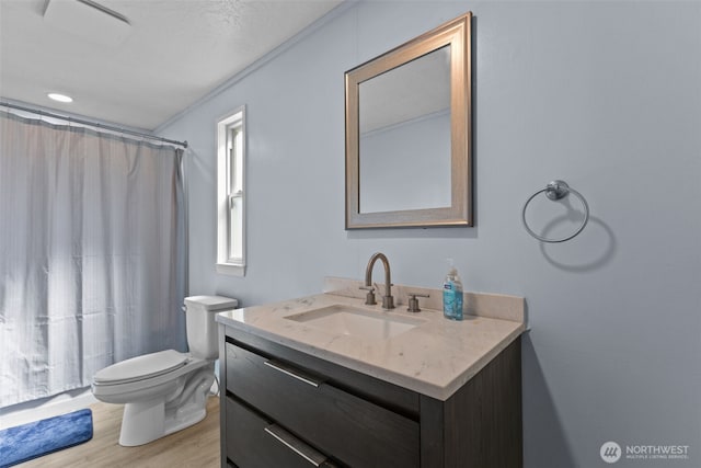 11519 21st Ave E Unit 84, Tacoma, WA 98445 - full bathroom featuring toilet, ornamental molding, a shower with shower curtain, vanity, and wood finished floors