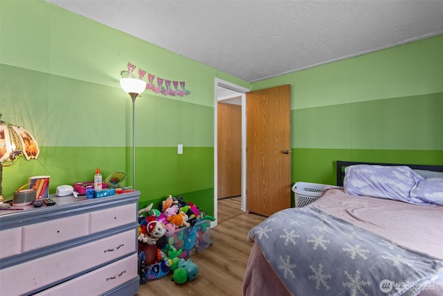 11519 21st Ave E Unit 84, Tacoma, WA 98445 - bedroom featuring a textured ceiling and wood finished floors