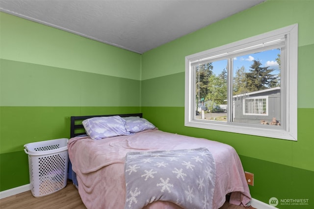11519 21st Ave E Unit 84, Tacoma, WA 98445 - bedroom with baseboards and wood finished floors