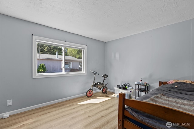 11519 21st Ave E Unit 84, Tacoma, WA 98445 - bedroom with a textured ceiling, wood finished floors, and baseboards