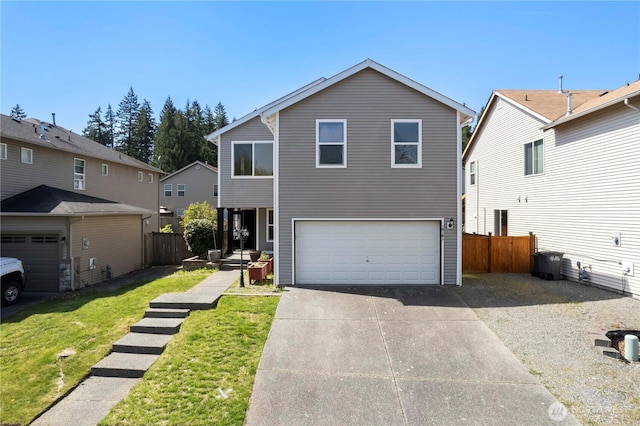 traditional home with an attached garage, a front lawn, fence, and concrete driveway