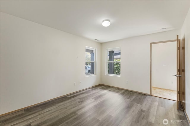 spare room with wood finished floors