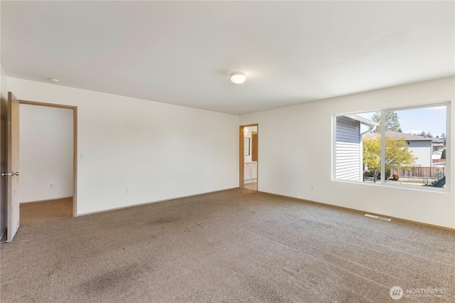 empty room featuring carpet flooring and visible vents