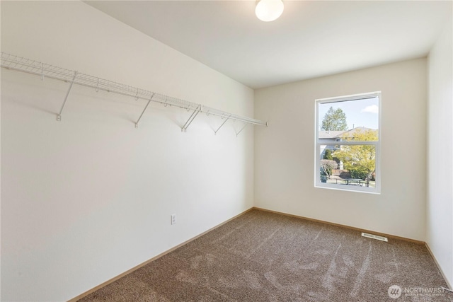 walk in closet with carpet floors and visible vents