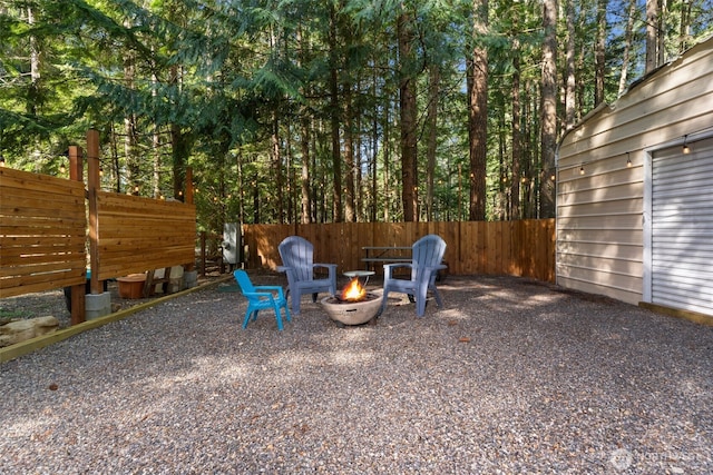 view of yard featuring fence and an outdoor fire pit