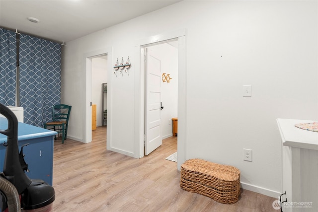 interior space with light wood finished floors and baseboards